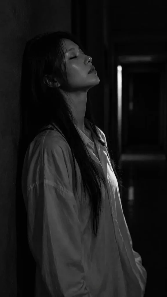 Low-Key Black and White Hallway Portrait