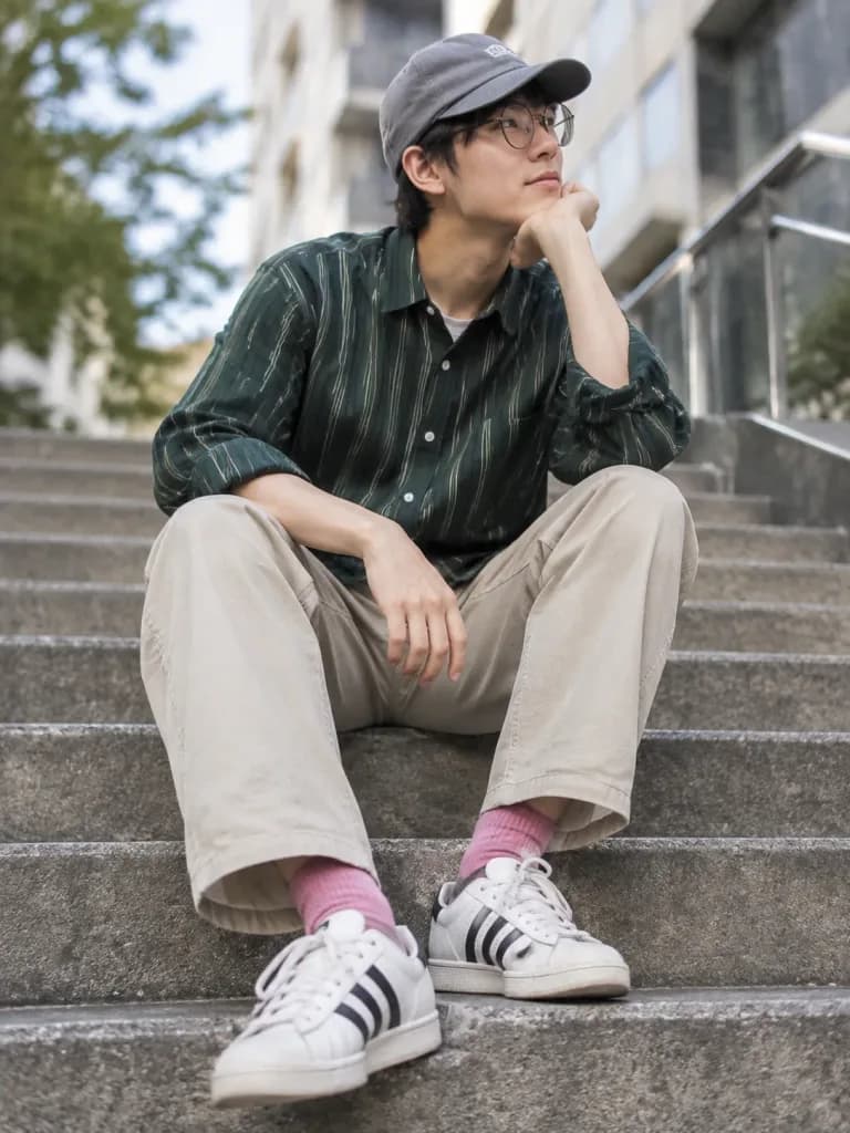 Young Man Sitting on Concrete Stairs