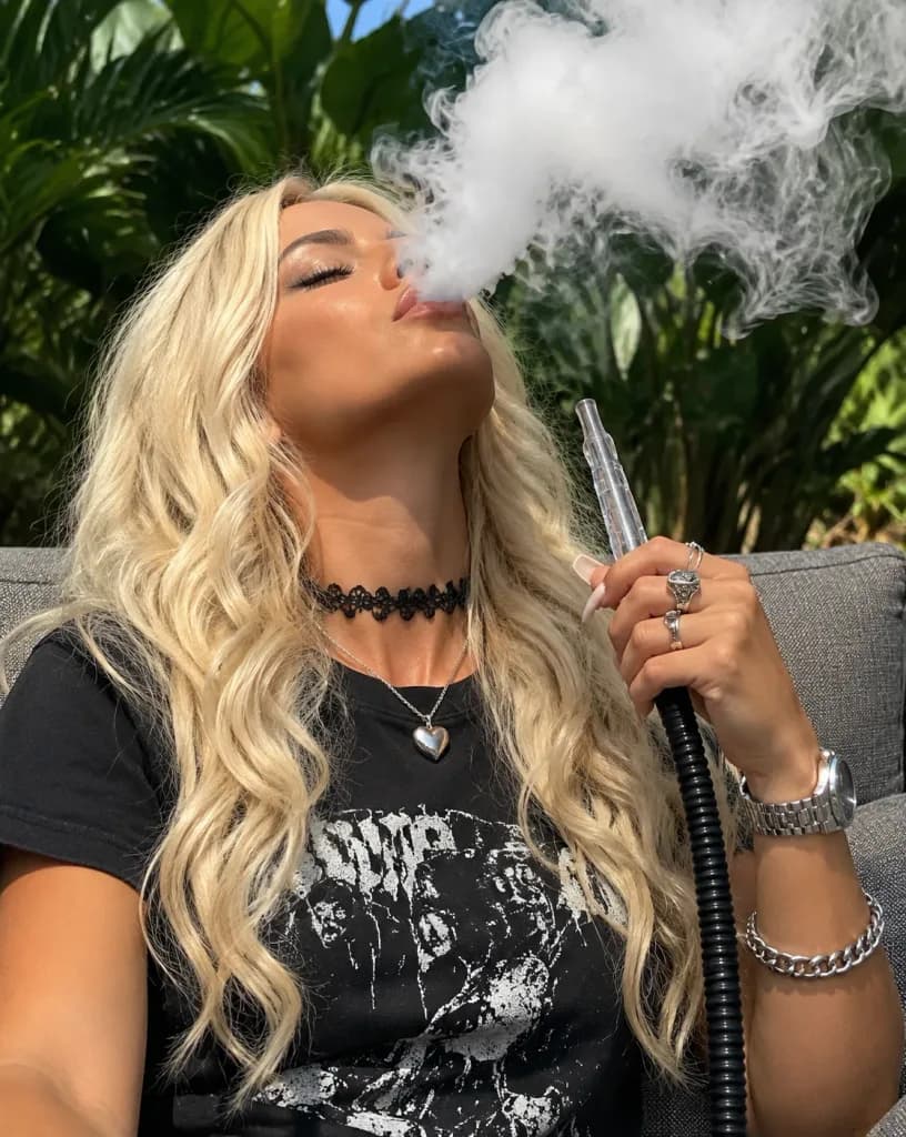 Woman Exhaling Hookah Smoke on Patio