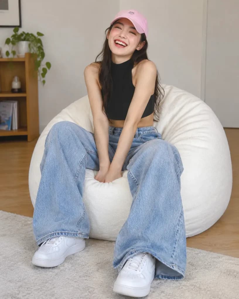 Donna che ride su un pouf bianco